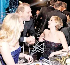  ??  ?? Weinstein (centre) and actress Jennifer Lawrence (right) in the audience during the 20th Annual Screen Actors Guild Awards on Jan 18, 2014 in Los Angeles, California. — AFP file photo