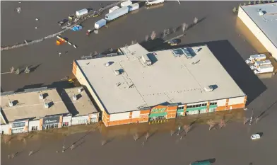  ?? GREG HALINDA / THE CANADIAN PRESS ?? The Sobeys grocery store in downtown Fort McMurray, Alta., is under water as is most of the city.