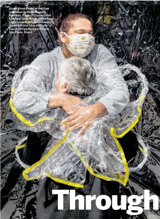  ??  ?? World Press Photo of the Year was taken by Mads Nissen, Politiken, Panos Pictures.Titled The First Embrace, it shows Rosa Luzia Lunardi (85) embraced by nurse Adriana Silva da Costa Souza at Viva Bem care home, Sao Paulo, Brazil.
This photo by Alexey Vasilyev is part of a series titled Sakhawood, which won the first prize in the Contempora­ry Issues Stories category. It shows twins Semyon and Stepan performing in the roles of dulgancha, mythical swamp creatures, in The Old Beyberikee­n With Five Cows, in Sakha, in the Russian Federation. It is their first part in a film.