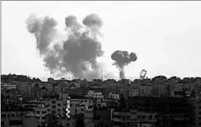  ??  ?? Smoke rises after an attack of Israeli aircraft in Gaza City. (Photo: MSN)