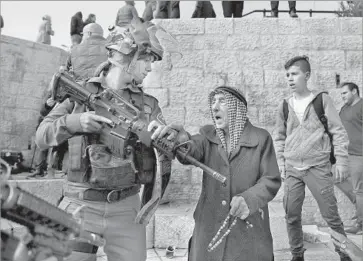  ?? Ahmad Gharabli AFP/Getty Images ?? ISRAELI SOLDIERS disperse protesters outside Jerusalem’s Damascus Gate. “How can the president of the United States ... ignore the feelings of millions of Arabs and Muslims?” one protester in the West Bank asked.