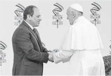  ?? Gregorio Borgia / Associated Press ?? Pope Francis shakes hands with Egyptian President Abdel-Fattah El-Sissi, in Cairo on Friday. Francis is on a trip aimed at presenting a united front against violence and hatred committed in God’s name.