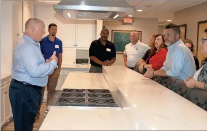  ?? Doug Walker ?? Southeaste­rn Mills VP for Technical Services Tom Reynolds gives a tour of the culinary kitchen in the new SEM Innovation Center.