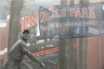  ?? Paul Chinn / The Chronicle ?? A banner was installed Thursday bearing the new name of the Giants’ stadium, Oracle Park. The Redwood City technology company and the Giants agreed to a 20-year naming-rights deal.