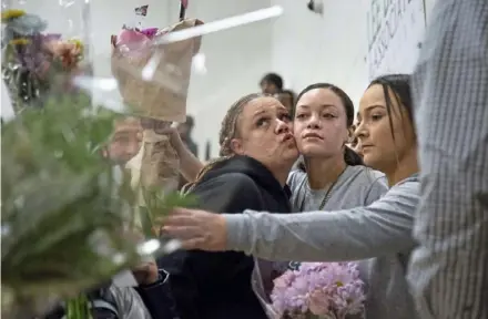  ?? Jessie Wardarski/Post-Gazette ?? Ciara Turner gets a kiss from family friend Shari Mowry before walking into the gymnasium with her best friend Trinity Cioppa for the Woodland Hills girls basketball senior night Feb. 8 at the school in Churchill.