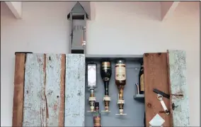  ??  ?? An old wooden kist used as a toolbox was dismantled and turned into a wine cabinet.