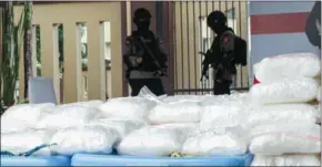  ?? AFP ?? Police guard the bags of seized methamphet­amine during a press conference in Jakarta.