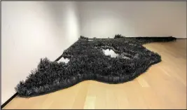  ?? Courtesy Images ?? Lauren Fenstersto­ck’s installati­on at the Walton Arts Center, titled “Colorless Field,” exists in variations of black — black paper, black sand and black Plexiglass.