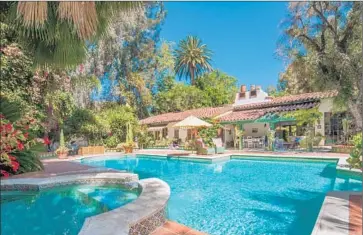  ?? Shooting LA ?? THE RESTORED Spanish hacienda- style house listed by actress Annie Potts features a rustic clay tile roof and f lagstone paths and patios. Priced at $ 6.495 million, the home includes two pools and a paddle tennis court.