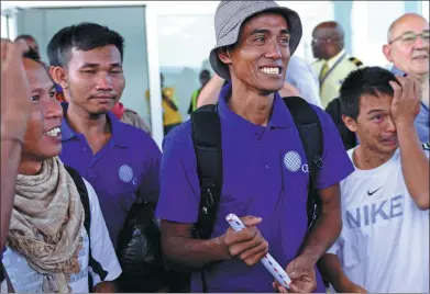  ?? AP ?? Sailors who were released in Somalia after being held hostage by pirates for more than four years smile, with tears in their eyes, as they arrive in Nairobi, Kenya, on Sunday.