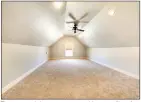  ?? ?? The carpeted bonus room provides a ceiling fan, recessed lighting, a window and a closet.