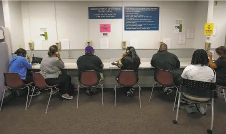  ?? Rich Pedroncell­i / Associated Press 2013 ?? Visitors use the Unemployme­nt Insurance phone bank at the California Employment Developmen­t Department in Sacramento.