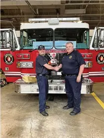  ?? ?? Lt. Adam Temple, who recently was promoted, is pictured with Huber Heights Fire Chief Keith Knisley.