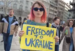  ?? ANDREJ ISAKOVIC/AFP VIA GETTY IMAGES ?? Protesters in Belgrade, Serbia, on Friday mark one year since the invasion of Ukraine by Russia. The White House announced Friday the Pentagon would commit $2 billion for the fight against Russia.