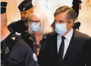  ?? Thomas Samson / AFP via Getty Images ?? Former French Prime minister Francois Fillon and wife Penelope Fillon leave the Paris courthouse.