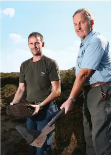  ??  ?? Left: Padraic Gilsenan with his cousins Annmarie and Lorraine Gilsenan after collecting the dried turf at Lisclogher Great in Co Westmeath. Above: Dermot Priest with his sleán, which was used to cut turf, and his son Diarmuid. Photo: Frank McGrath