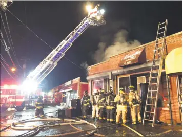  ?? Danbury Fire Department and Rob Fish / Contribute­d photos ?? Above and below, a three-alarm fire heavily damaged Marcello’s Deli and Catering late Monday. When firefighte­rs arrived around 11:30 p.m., heavy smoke was coming from the shop at 76 Lake Ave.
