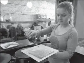  ?? PHOTOS BY CHRISTINA JONAS ?? Heidi Papatolika­s of Pavillion Coffee and Crepes prepares a maple crepe that features a brown sugar and walnut filling, and is topped with maple syrup and powdered sugar.