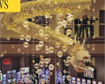  ?? ETHAN MILLER / GETTY IMAGES ?? A 1.25-ton glass dragon chandelier hangs as the centrepiec­e of Lucky Dragon Hotel & Casino in Las Vegas during its grand opening Dec. 3. The resort is designed to give visitors an authentic Asian cultural and gambling experience.