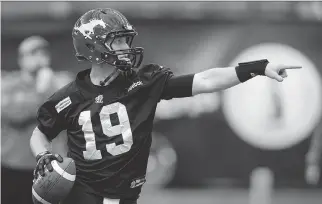  ?? PAUL CHIASSON/ CANADIAN PRESS ?? Calgary Stampeders’ quarterbac­k Bo Levi Mitchell points to a receiver during practice Friday in Vancouver. His college coach says he stays cool even when things don’t go his way.