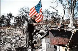  ?? JOHN LOCHER/AP ?? at the charred remnants of his godfather Ed Bledsoe’s home Sunday in Redding, Calif. Bledsoe’s wife, Melody, great-grandson James Roberts and great-granddaugh­ter Emily Roberts were killed at the home in the Carr Fire.