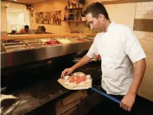  ?? EMILY MICHOT emichot@miamiheral­d.com ?? Chef Renato Viola, co-owner of Mister O1, works on creating a Star Luca pizza, a favorite at the Miami Beach pizzeria.