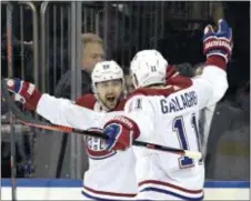  ?? BILL KOSTROUN — THE ASSOCIATED PRESS ?? Montreal Canadiens left wing Tomas Tatar (90) and right wing Brendan Gallagher (11) celebrate a goal by Tatar during the first period against the Rangers.