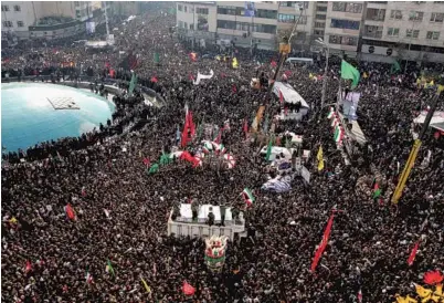  ?? ATTA KENARE/GETTY-AFP ?? Mourners take part in a funeral procession in Tehran for Gen. Qassem Soleimani, Abu Mahdi al-Muhandis and others killed in a U.S. attack.