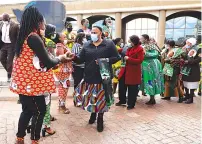  ?? — ?? ZANU PF women’s league secretary Cde Mabel Chinomona (front) greets party members showcasing regalia accompanie­d by secretary for administra­tion Cde Monica Mutsvangwa (in red jacket) at the party Headqaurte­rs in Harare yesterday. Pictures: Memory Mangombe