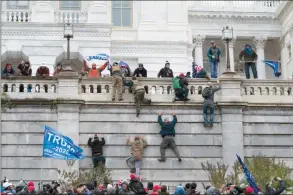 ?? The Associated Press ?? Supporters of President Donald Trump climb the west wall of the the U.S. Capitol in Washington on Jan. 6.