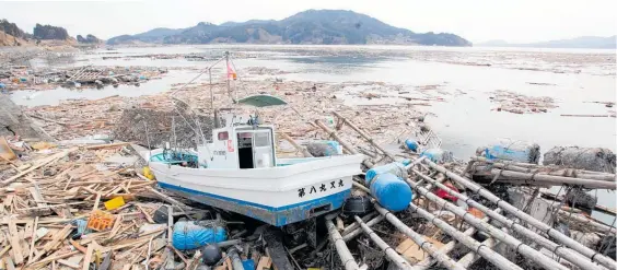  ?? Photo / NZPA / Bradley Ambrose ?? Debris two weeks after Japan’s devastatin­g 9.1 “megathrust” quake and tsunami in 2011.