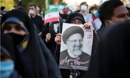  ?? Photograph: Sobhan Farajvan/Pacific Press/Rex/ Shuttersto­ck ?? Supporters hold a poster of the hardline candidate Ebrahim Raisi in Tehran on 11 June.