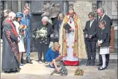  ?? BEN STANSALL — PA VIA AP ?? Lucy Hawking lays flowers as the ashes of her father, scientist Stephen Hawking, are laid to rest at Westminste­r Abbey in London on Friday.