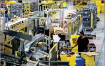  ?? WATCHARA PHOMICINDA — STAFF PHOTOGRAPH­ER ?? Amazon is hiring 250,000 U.S. workers, including 16,000 in Southern California, to fill full-time, seasonal and part-time roles across its operations network. A worker is seen here processing a package at an Amazon fulfillmen­t center in Eastvale.