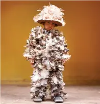  ?? AP Photo/Jorge Saenz ?? ■ Four-year-old Josia Sebastian Yegros poses for a photo Wednesday wearing his feathered costume during the feast of St. Francis Solano in Emboscada, Paraguay.