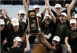  ?? MORRY GASH — THE ASSOCIATED PRESS ?? Stanford players celebrate with the trophy after edging Arizona, 54-53, to win their first NCAA Women’s Basketball Championsh­ip since 1992on Sunday in San Antonio, Texas.