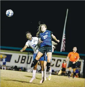  ?? Photo courtesy of JBU Sports Informatio­n ?? John Brown’s Renny Buchanan (right) battles Lindsey Wilson’s Yudaya Nakayenze for a ball in the air during last Saturday’s game at Alumni Field. Lindsey Wilson defeated John Brown 2-1 to end the Golden Eagles’ 22-match unbeaten streak at Alumni Field.