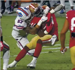  ?? ROSS D. FRANKLIN — THE ASSOCIATED PRESS ?? 49ers running back Jeff Wilson gets dragged down by Bills defensive end A.J. Epenesa in the second half Monday at State Farm Stadium in Glendale, Ariz.