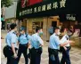  ?? ?? Police officers at the scene of the crime in Canton Road.