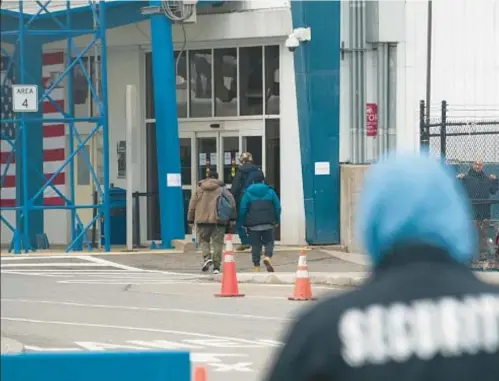  ?? ?? Migrants enter Brooklyn Cruise Terminal shelter, a facility that would be illegal under the city’s right-to-shelter law.