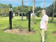  ?? MARTIN E. COMAS/ORLANDO SENTINEL ?? Sanford resident Bob Walko stands by a sign that was recently removed by city workers that named Roy Williams Park on Aug. 11.