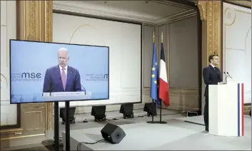  ?? AP photo ?? French President Emmanuel Macron (right) attends a video-conference meeting as U.S. President Joe Biden appear on a screen ahead of a 2021 Munich Security Conference at the Elysee palace in Paris, on Friday.