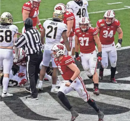  ?? JIM DEDMON / USA TODAY SPORTS ?? Badgers quarterbac­k Graham Mertz celebrates one of his two rushing touchdowns Wednesday.