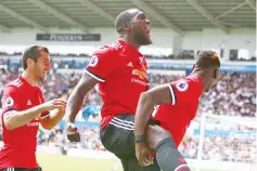  ?? — AFP photo ?? Manchester United’s Belgian striker Romelu Lukaku (C) and Manchester United’s French midfielder Paul Pogba (R) celebrate scoring the team’s fourth goal during the English Premier League football match between Swansea City and Manchester United at The...