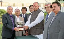  ?? — DECCAN CHRONICLE ?? Rafeeq Iqbal (left) and K.S.N. Murthy (second from left) receive the A.P. Race Horse Owners Associatio­n Trophy from Prem Singh Rathore after Beau Ideal won the main event of the races held in Hyderabad on Monday.