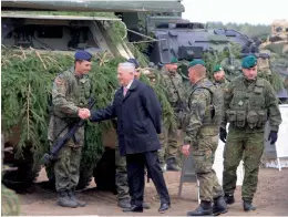  ?? — AP ?? US defence secretary James Mattis shakes hands with a German soldier as he meets with US troops deployed in Lithuania, with representa­tives of the Lithuanian Armed Forces and soldiers of the Nato-enhanced Forward Presence Battalion Battlegrou­p in...