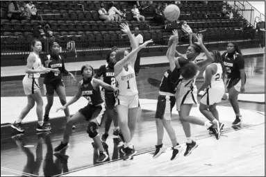  ?? Photo by Alexis Meeks ?? A Malvern 9th grade Lady Cub takes a shot over two Hot Springs defenders during Tuesday’s game.