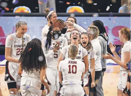  ?? TROY TAORMINA/ USA TODAY SPORTS ?? Stanford players celebrate after winning the Cardinal’s third women’s college basketball championsh­ip with a 54- 53 victory over Pac- 12 rival Arizona on Sunday. It was Stanford’s first national title since 1992.