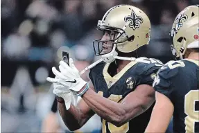  ?? BILL FEIG THE ASSOCIATED PRESS ?? New Orleans Saints wide receiver Michael Thomas pulls out a cellphone after his 72-yard touchdown Sunday against the Los Angeles Rams.