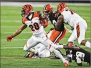  ?? PHOTOS BY RON SCHWANE / AP ?? Bengals tailback Joe Mixon (left), breaking free from the Browns last season, will look to bounce back today from last week’s 33-yard effort.